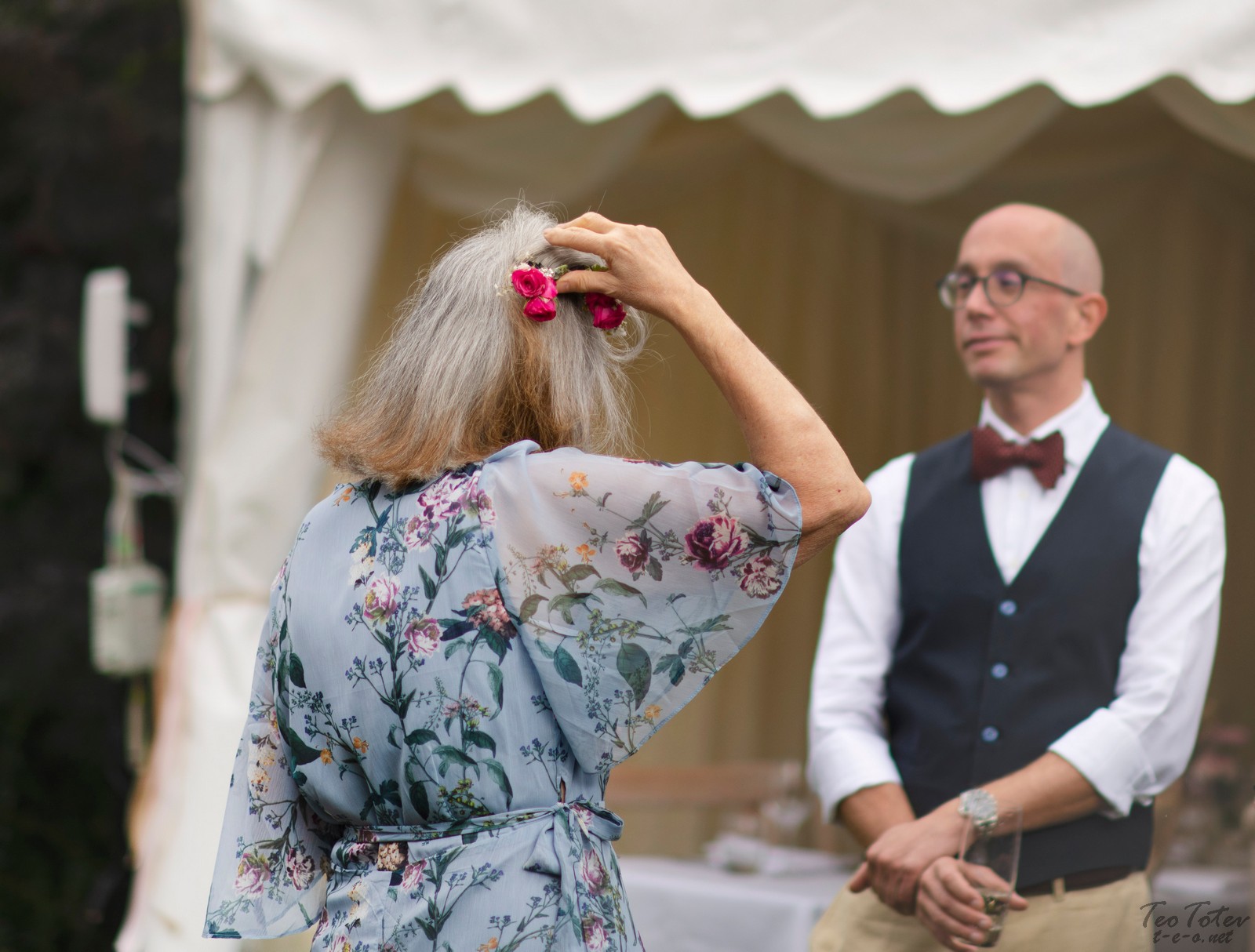 Adjusting flower in hair