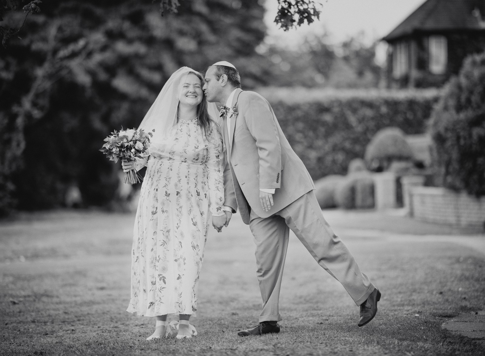 Lean to kiss the bride in BW